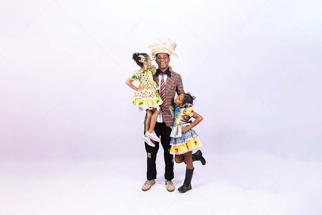 Pai ao lado de suas filhas felizes celebrando São João