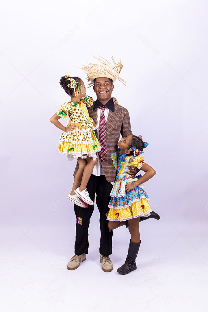 Pai ao lado de suas filhas felizes celebrando São João