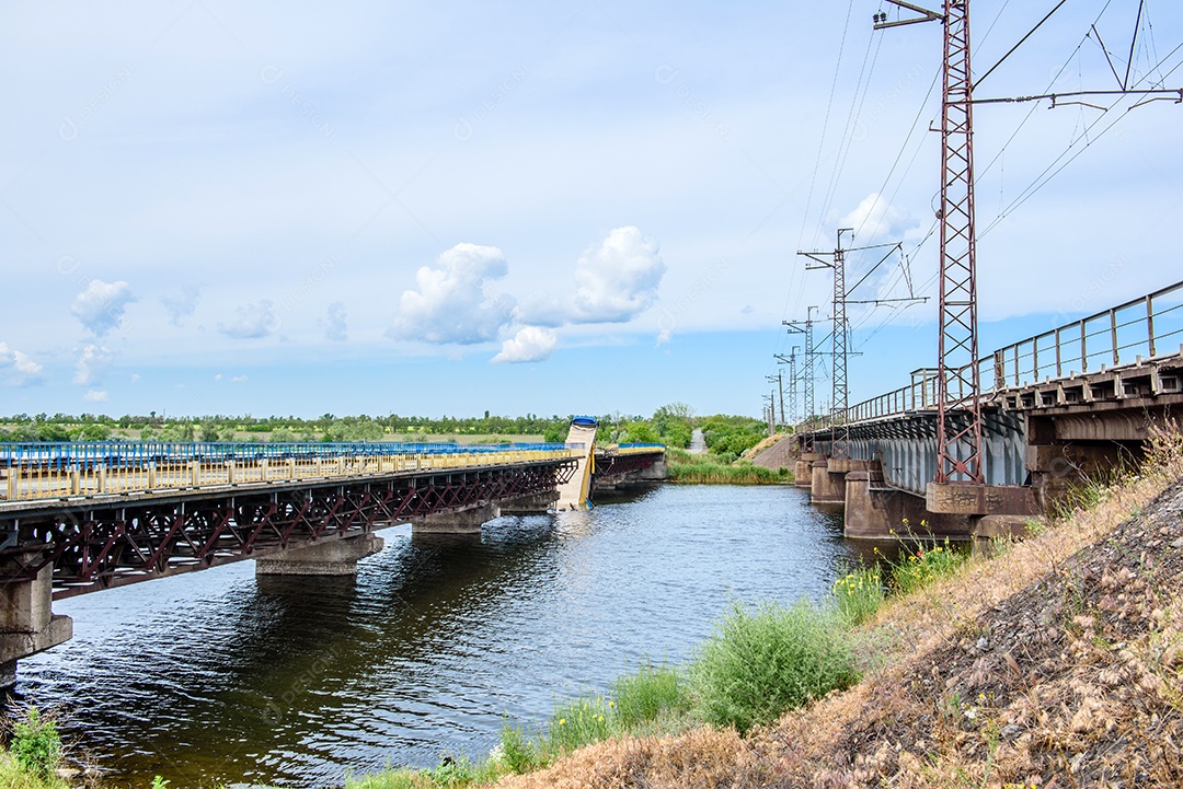 Destruição de estruturas de pontes sobre o rio com desabamento de trechos na água. Acidente de caminhão em ponte destruída