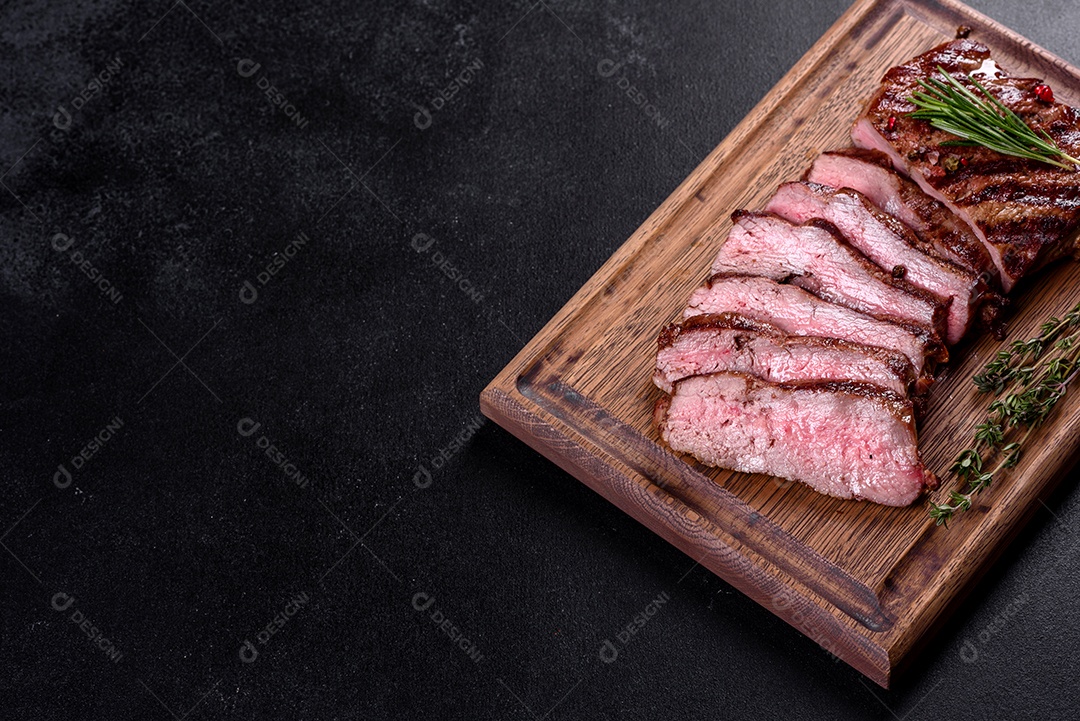 Bife fresco, suculento e delicioso em um fundo escuro.