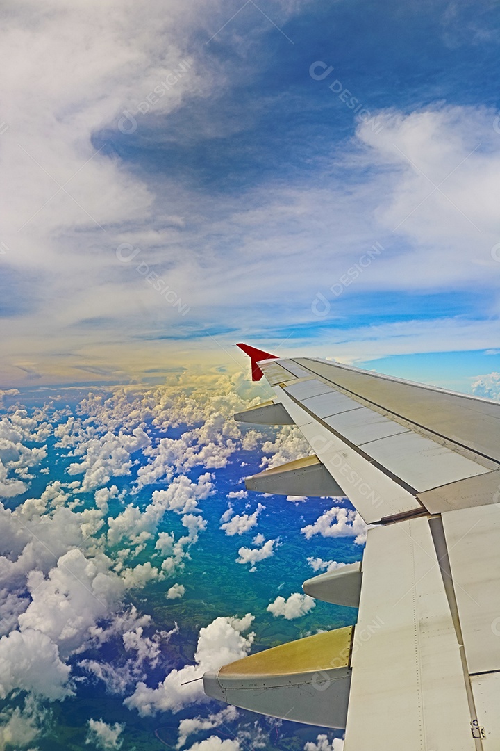 Asa de um avião voando acima da cidade A vista de uma janela de avião. Céu nublado e colorido com luz solar