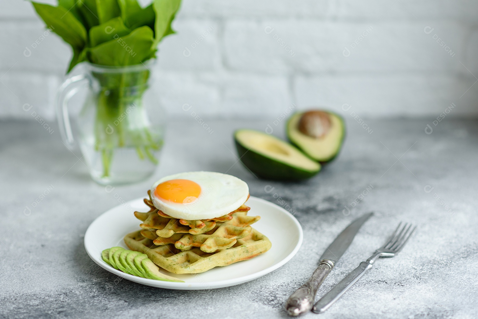 Pequeno-almoço fresco, delicioso e nutritivo com waffles com espinafre, ovo frito e pedaços de abacate