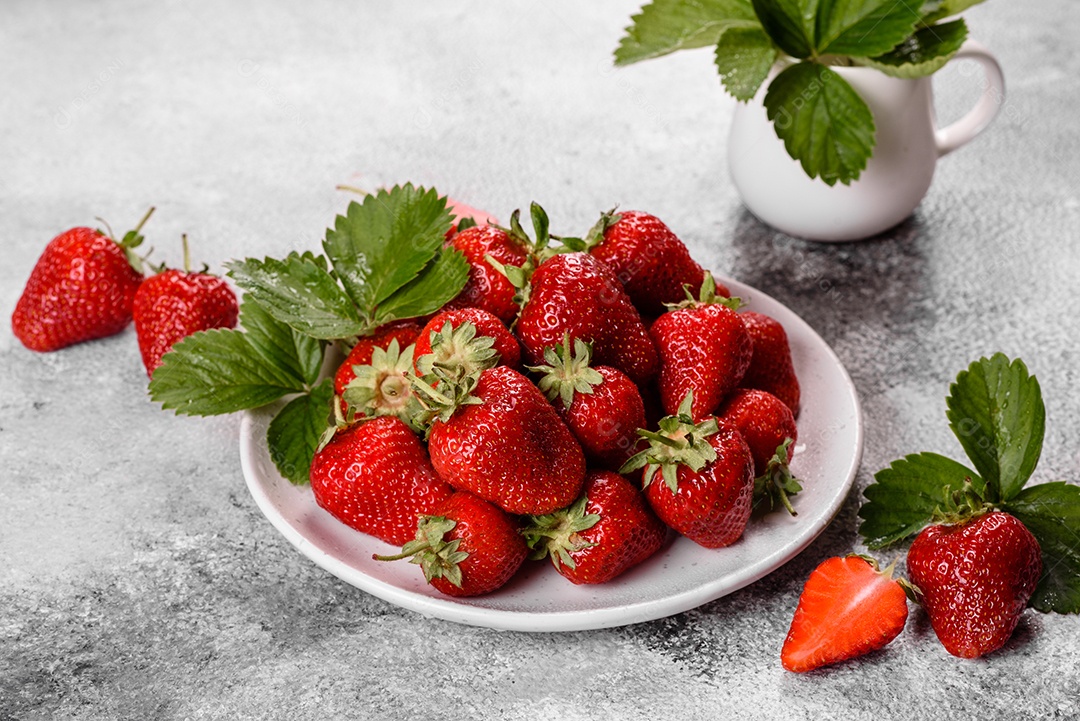 Morangos frescos e suculentos com folhas. Colheita fresca de verão de morangos