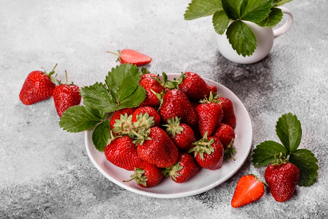 Morangos frescos e suculentos com folhas. Colheita fresca de verão de morangos