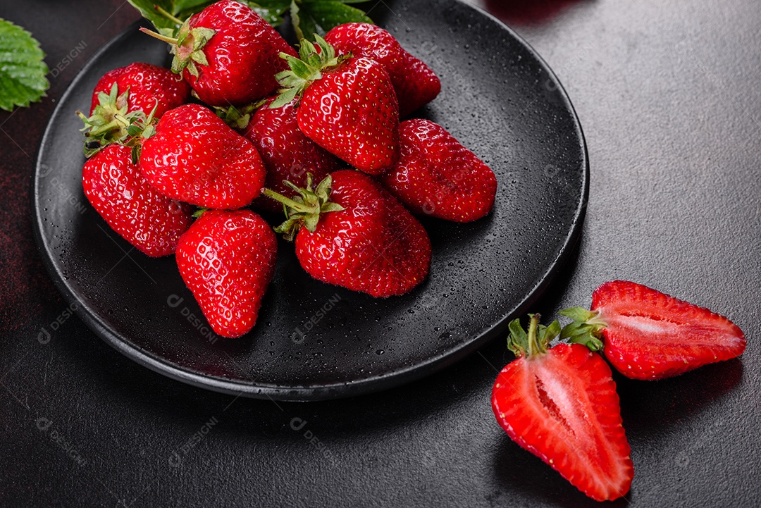 Morangos frescos e suculentos com folhas. Colheita fresca de verão de morangos