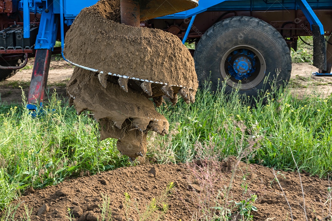 Trator traçador com trado para perfuração de solo para estacas