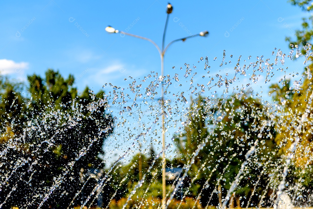 Gotas turvas de uma fonte de água, luz desfocada, desfoque bokeh