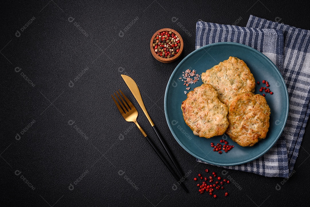 Deliciosas costeletas de peixe picado frito fresco com especiarias e ervas sobre um fundo escuro de concreto