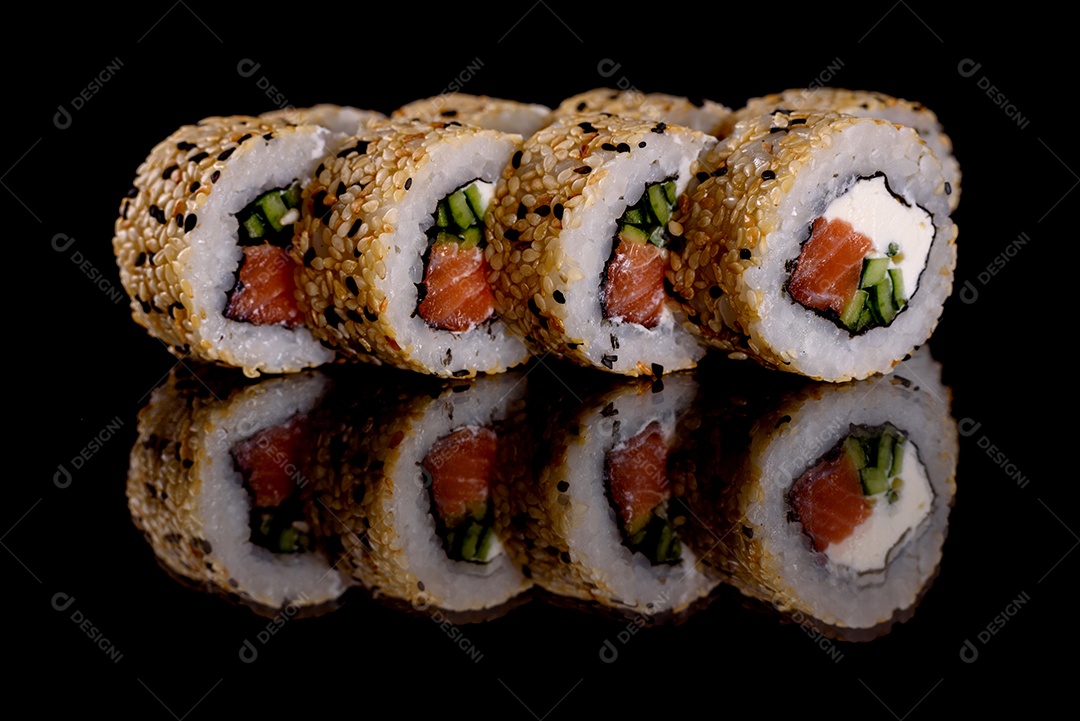 Rolos de sushi lindos e deliciosos frescos em um fundo preto. Elementos da culinária japonesa