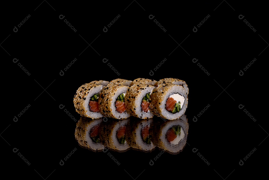Rolos de sushi lindos e deliciosos frescos em um fundo preto. Elementos da culinária japonesa