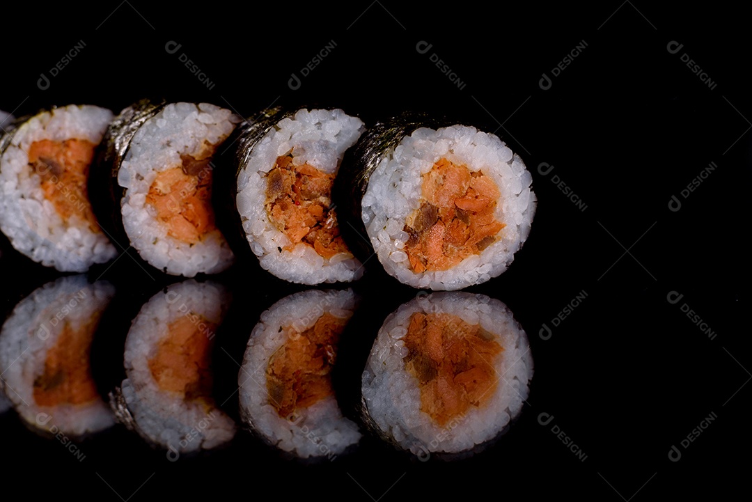 Rolos de sushi lindos e deliciosos frescos em um fundo escuro. Elementos da culinária japonesa