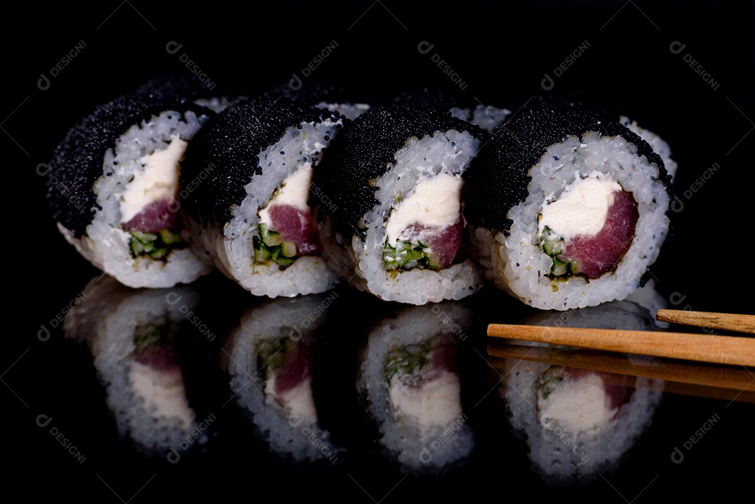 Rolos de sushi lindos e deliciosos frescos em um fundo escuro. Elementos da culinária japonesa