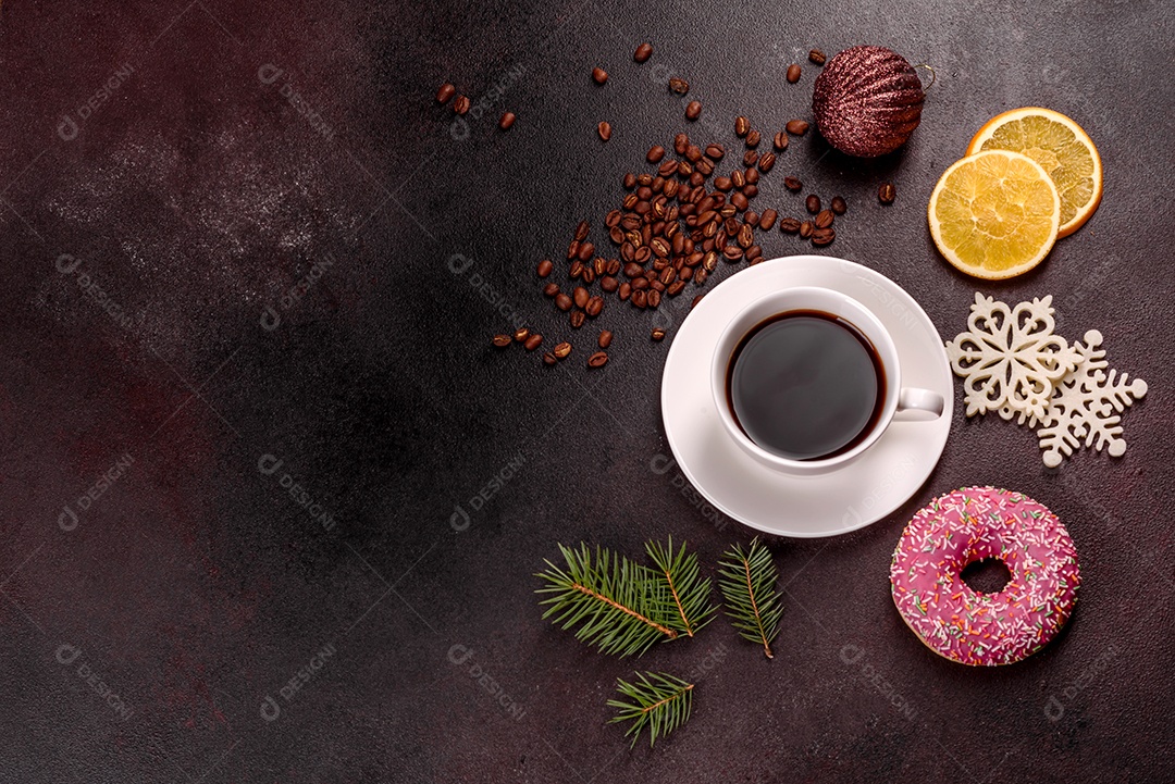 Uma xícara de café forte na mesa de Natal com galhos de abeto e brinquedos.