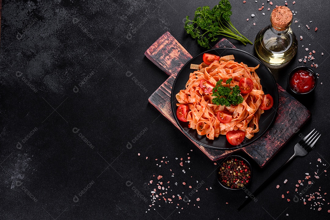 Deliciosa pasta fresca com molho de tomate com especiarias e ervas sobre fundo escuro. Cozinha mediterrânea