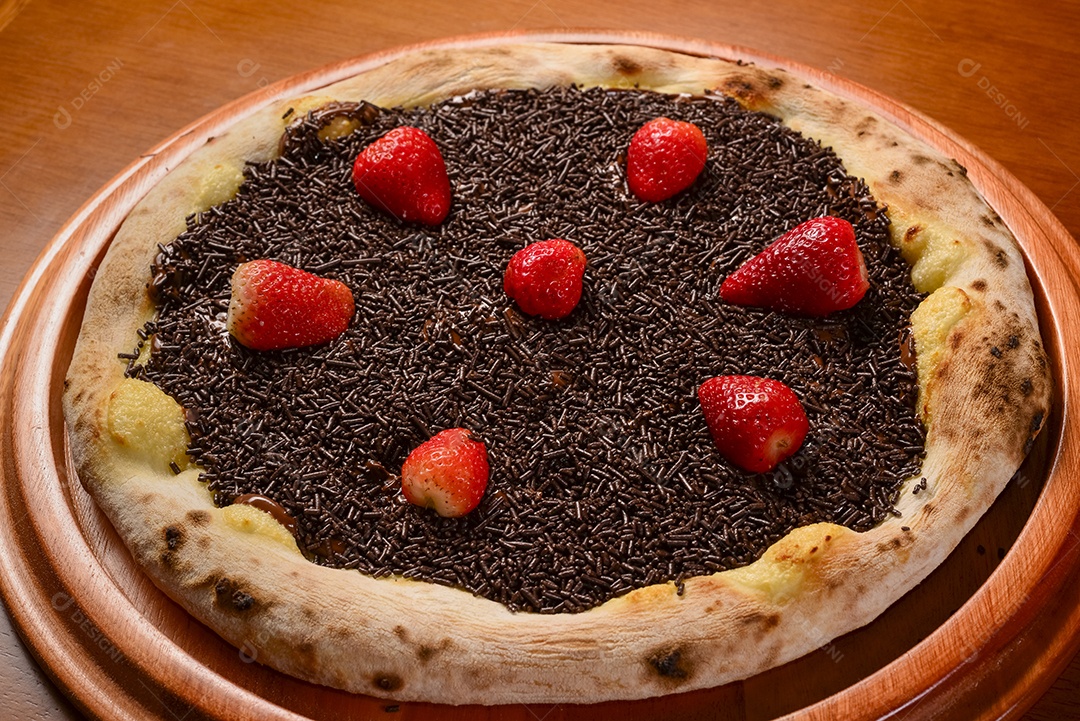 Pizza de morango com chocolate na mesa de madeira