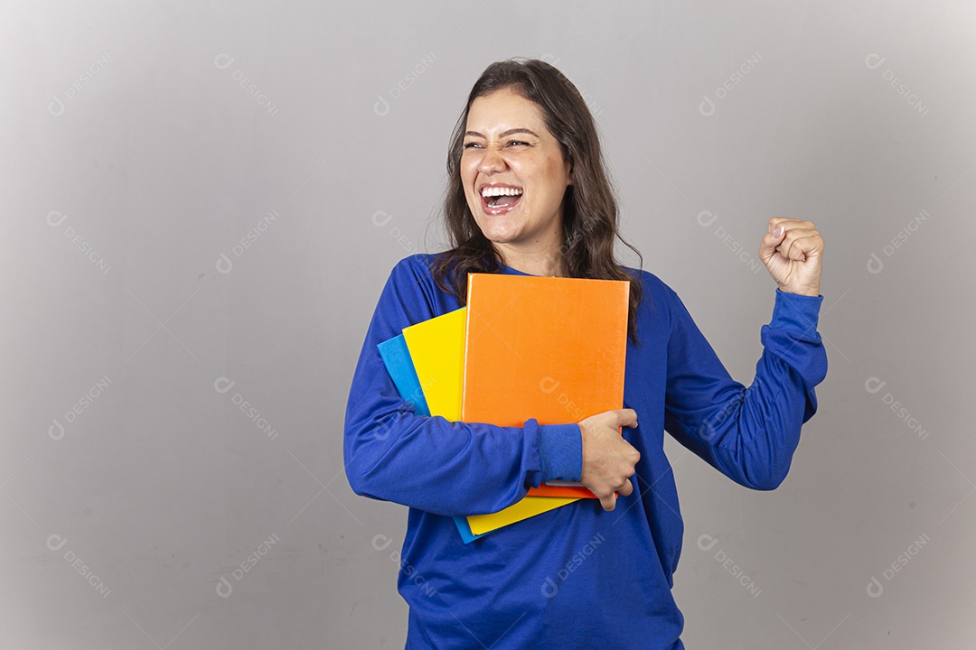 Jovem mulher vestida com moletom azul segurando livros.