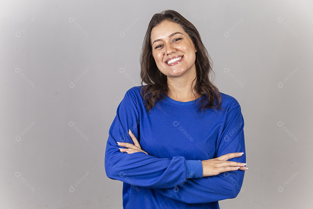 Jovem mulher vestida com moletom azul de braços cruzados.