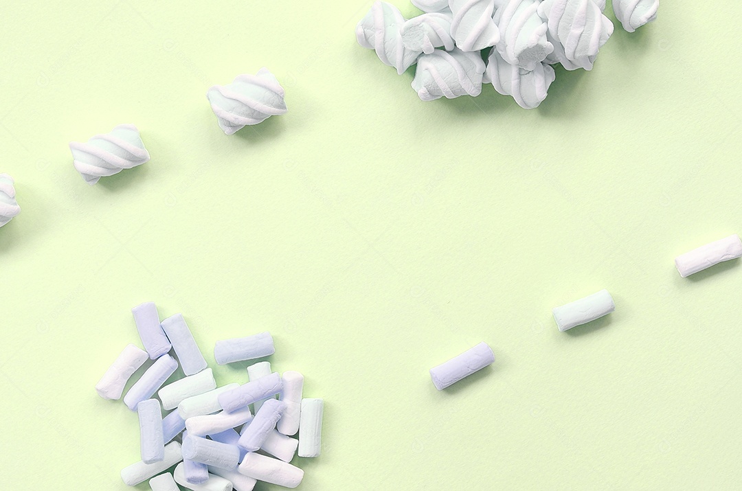 Muitos marshmallow colorido disposto em fundo de papel limão