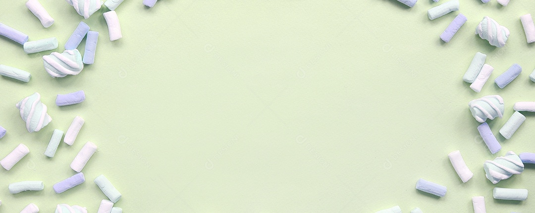 Muitos marshmallow colorido disposto em fundo de papel limão