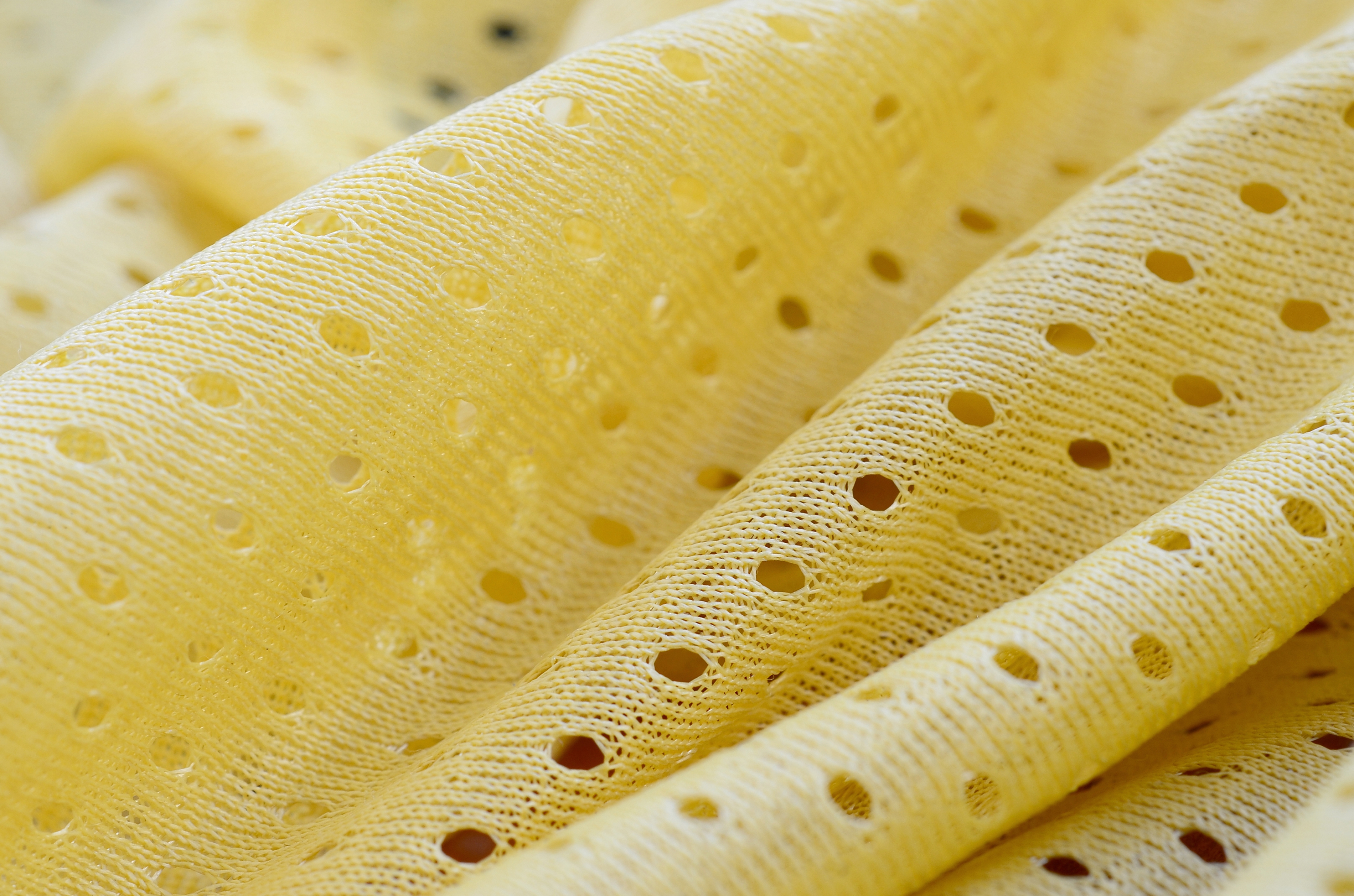 Padrão de fundo têxtil de tecido de desgaste esportivo de malha amarela