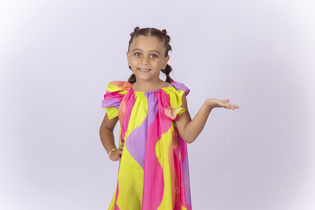Menina sorridente usando vestido colorido sobre um fundo isolado branco.