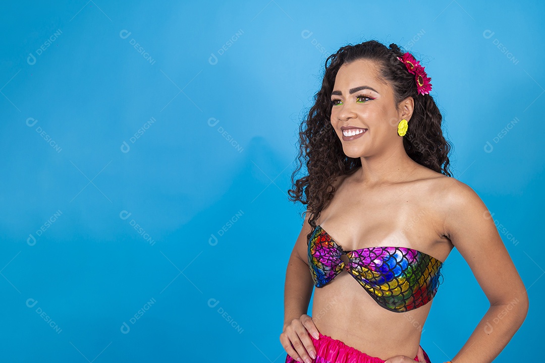 Linda mulher vestida com fantasia de carnaval sobre um fundo isolado azul.