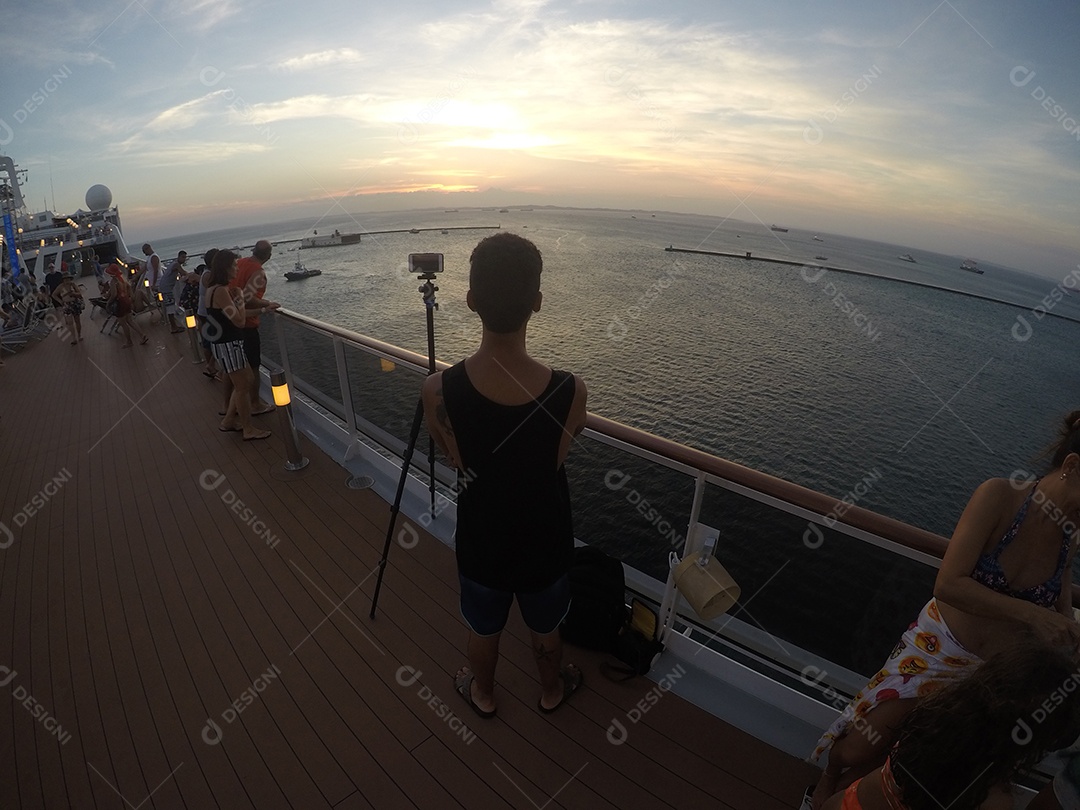 Retrato de um jovem turista negro no convés de um navio de cruzeiro em frente ao pôr do sol