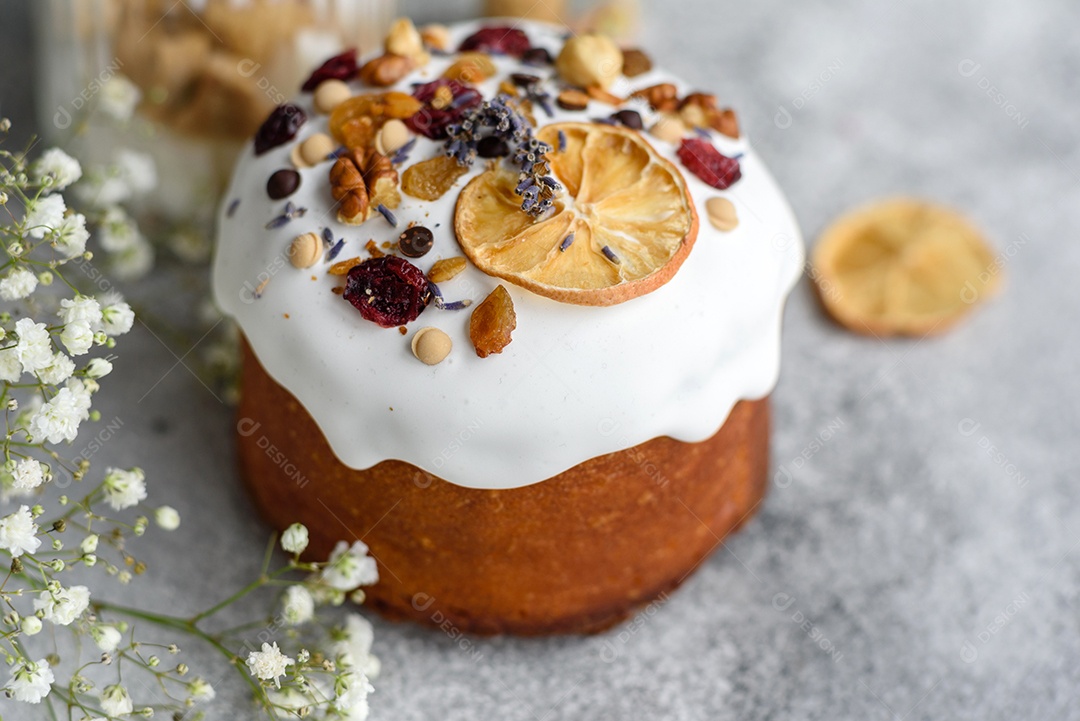 Bolos festivos com esmalte branco, nozes e passas com ovos de Páscoa na mesa festiva. Preparativos para a Páscoa