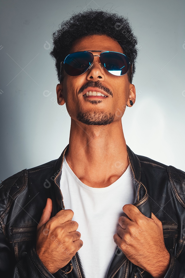 Homem jovem usando jaqueta de coura preta sobre fundo isolado