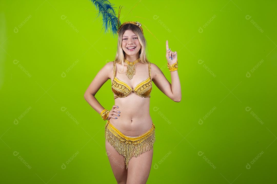 Linda passista loira fantasiada para o carnaval sobre um fundo isolado verde.