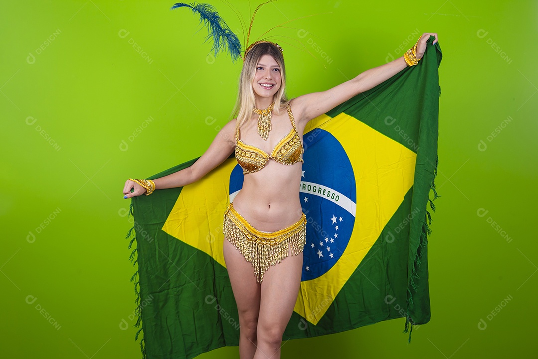 Linda passista loira fantasiada para o carnaval segurando bandeira do Brasil.