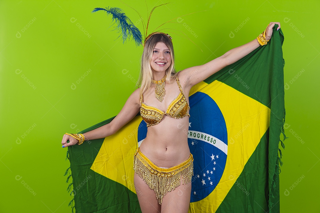 Linda passista loira fantasiada para o carnaval segurando bandeira do Brasil.