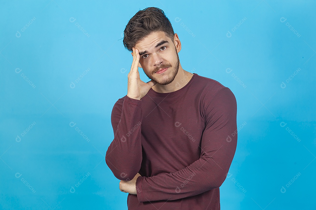 Homem de camisa manga longa sobre fundo isolado azul.