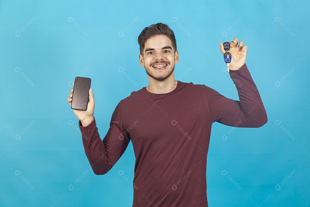 Homem sorridente segurando celular sobre um fundo isolado azul.