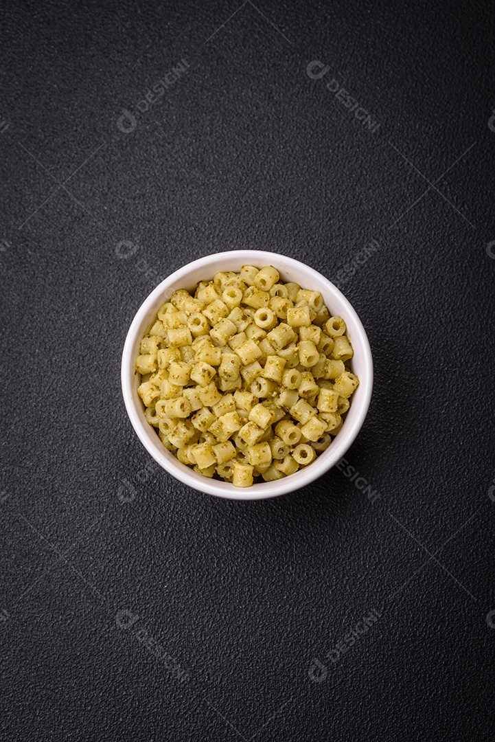 Deliciosa massa ditali de trigo duro com sal e especiarias sobre um fundo escuro de concreto