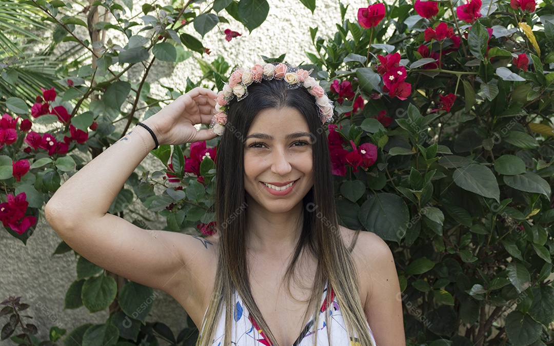 Menina adolescente morena bonita com tiara florida ou faixa de cabelo no jardim conceito de fantasia hippie