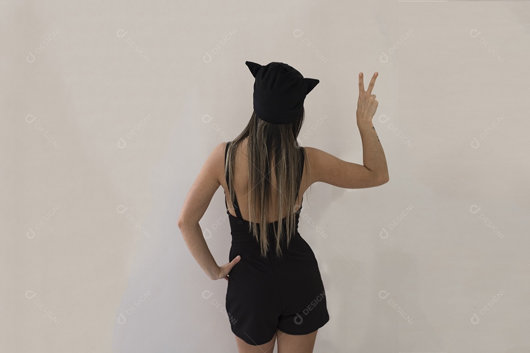 Menina de costa e fantasia de gato isolada em fundo branco