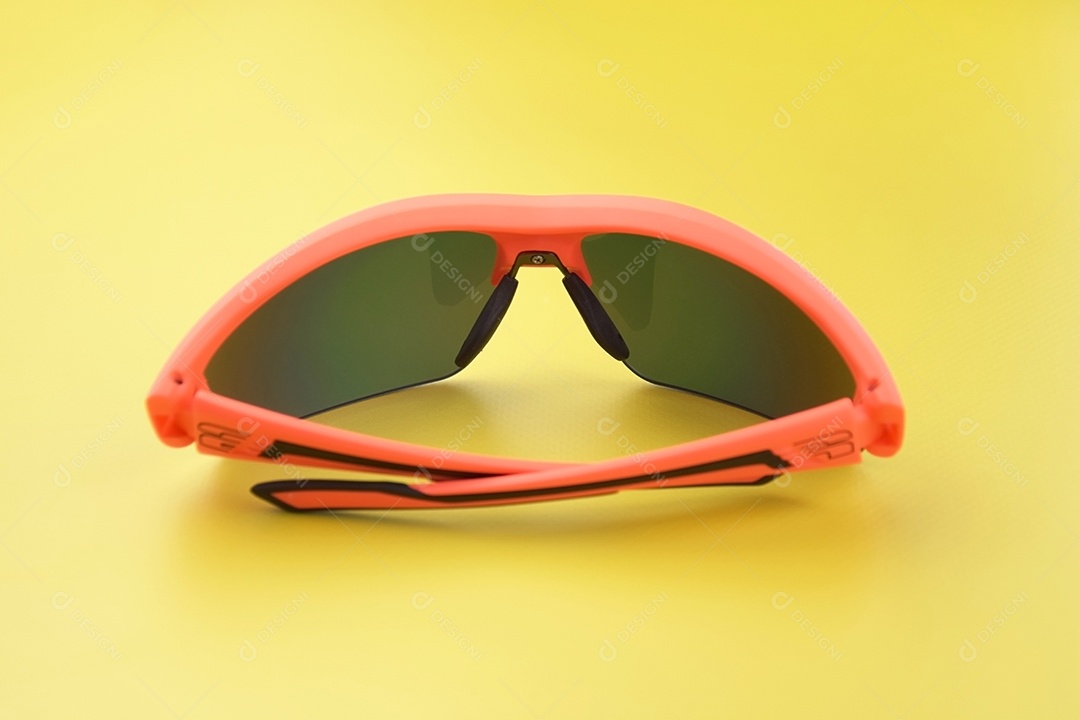 Óculos esportivos feitos de plástico laranja com lentes amarelas