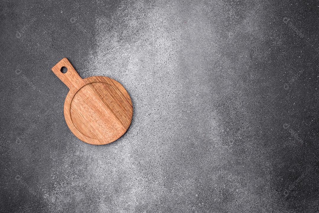 Tábua de corte de madeira vazia sobre um fundo de textura leve. Utensílios de cozinha