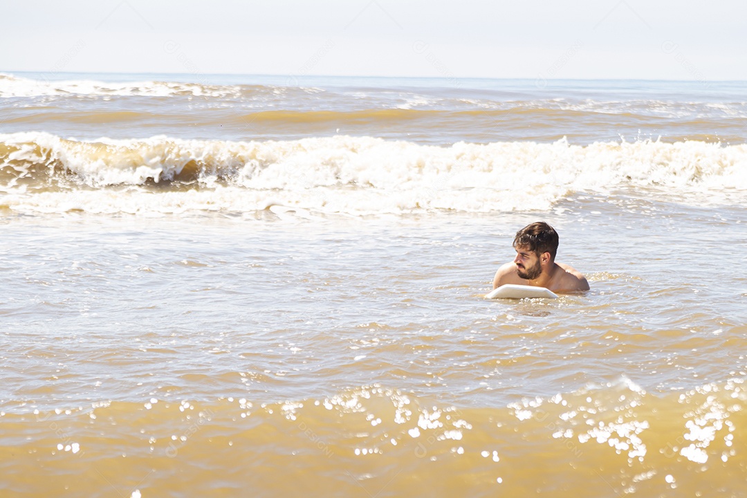 Homem jovem sobre praia curtindo verão