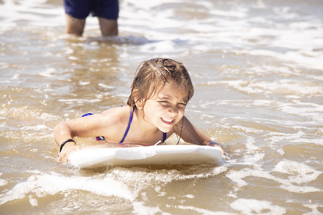 Pai ao lado de sua filha curtindo verão sobre uma praia