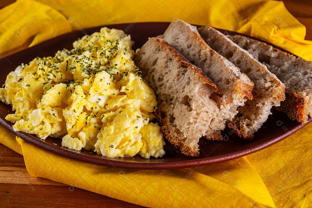 Ovos mexidos e fatias de pão artesanal