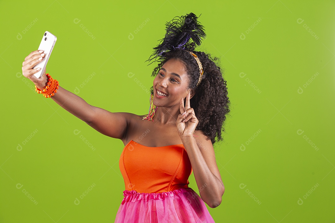 Linda mulher jovem celebrando carnaval segurando celular smartphone