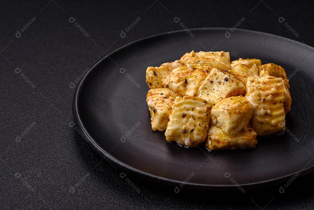 Delicioso queijo feta branco macio com sal, especiarias e ervas sobre um fundo escuro de concreto. Ingredientes para pratos mediterrâneos
