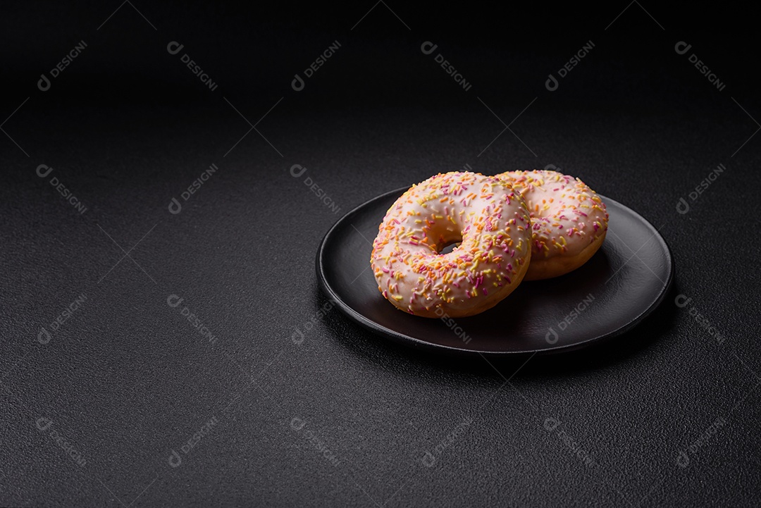 Deliciosos donuts doces e brilhantes com creme em um fundo liso. Atributo da tabela de feriados