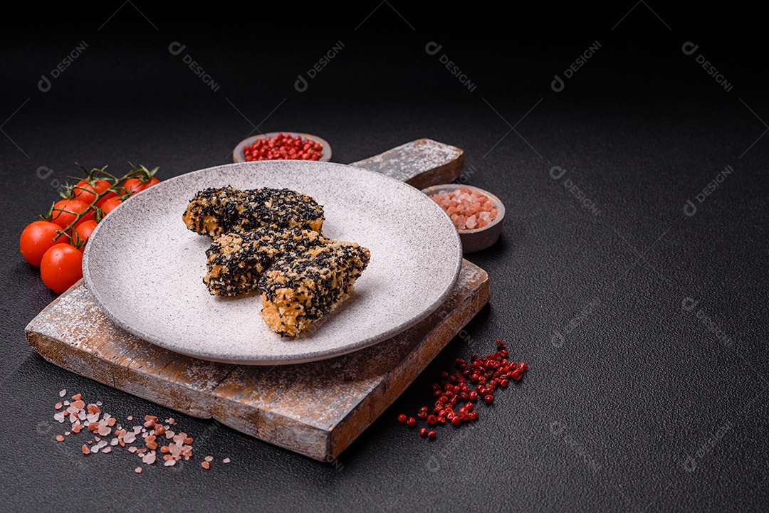 Deliciosos nuggets de frango ou peixe crocantes frescos em um fundo escuro de concreto. Alimentos não saudáveis, fast food