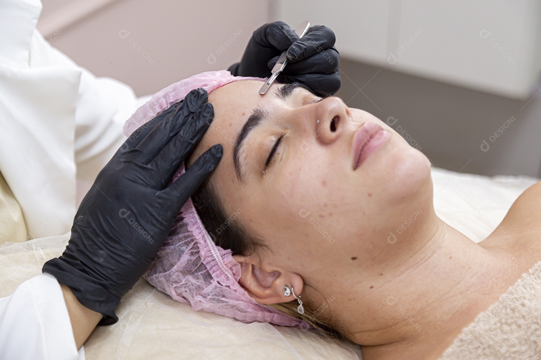 Mulher jovem realizando procedimentos estéticos em uma mulher