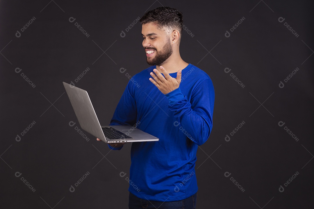 Homem jovem garoto barbudo sobre fundo isolado segurando notebook