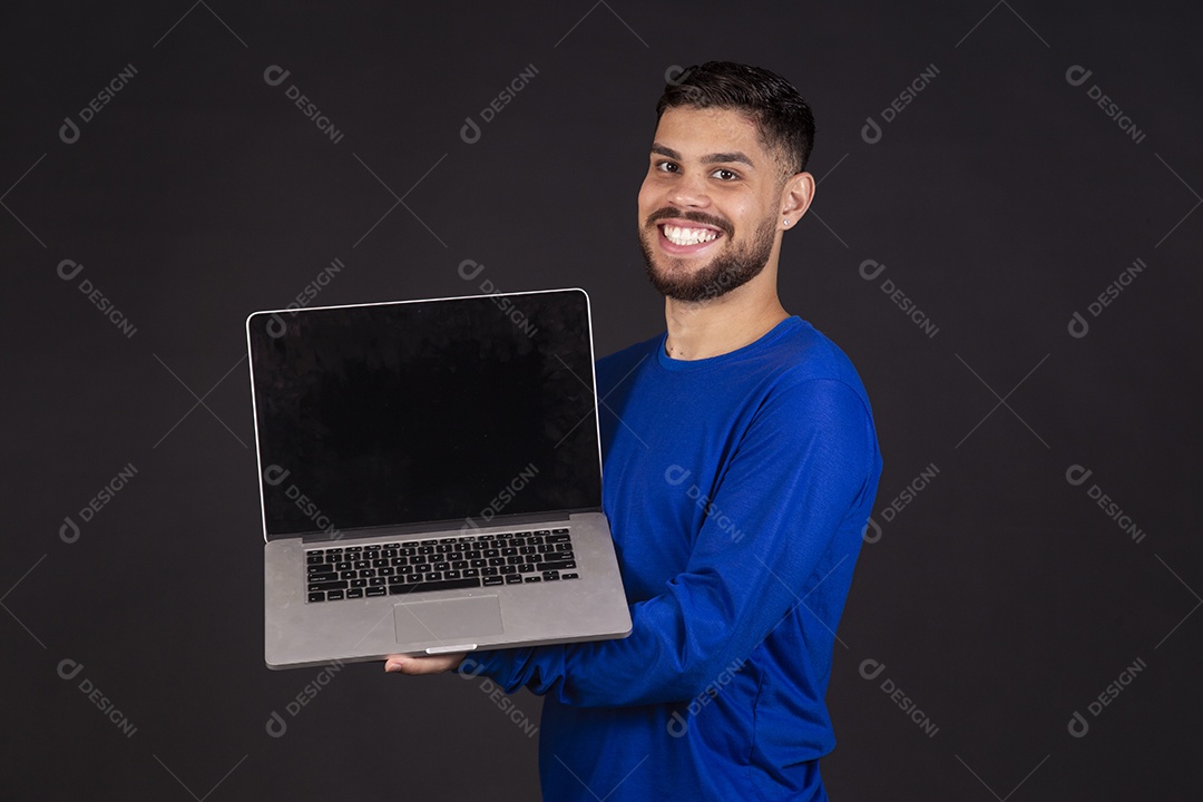 Homem jovem garoto barbudo sobre fundo isolado segurando notebook