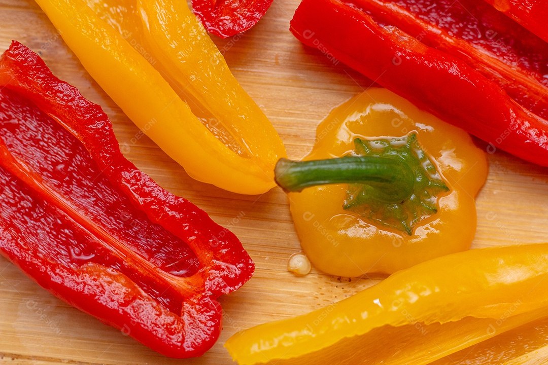 Pimentões vermelhos e amarelos sobre uma tábua